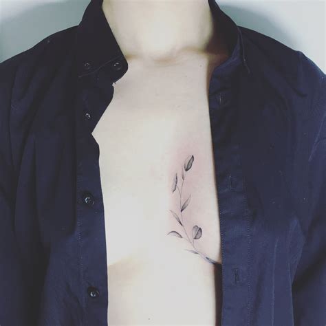 tattoos between your breast|Between Breast Tattoo Meaning: Personal Stories。